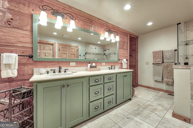 bathroom with tiled shower, a sink, visible vents, and wooden walls