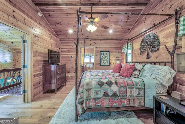 bedroom featuring lofted ceiling, hardwood / wood-style floors, wooden ceiling, and wooden walls