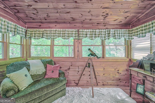 sunroom featuring vaulted ceiling and wooden ceiling