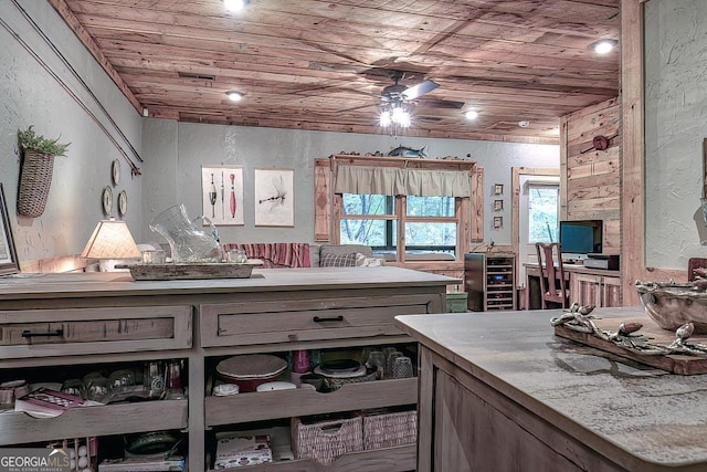 kitchen featuring wooden ceiling, wine cooler, light countertops, and a textured wall