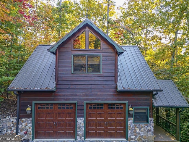 view of property exterior with stone siding and metal roof