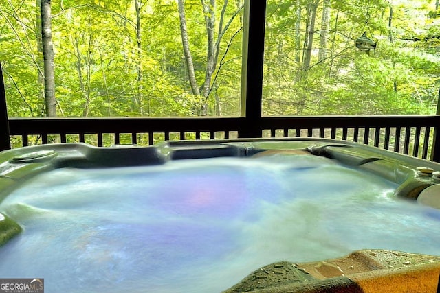 wooden deck featuring a hot tub