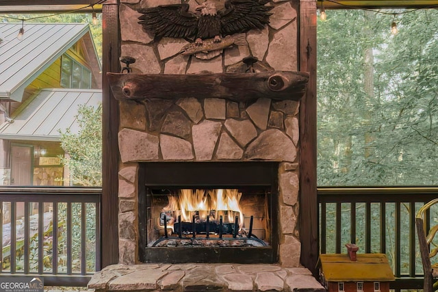 details with an outdoor stone fireplace