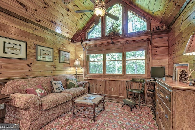 carpeted living area featuring a ceiling fan, wood ceiling, a healthy amount of sunlight, and wooden walls