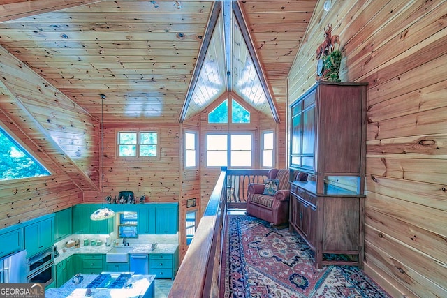 interior space featuring high vaulted ceiling, wooden walls, sink, and wood ceiling