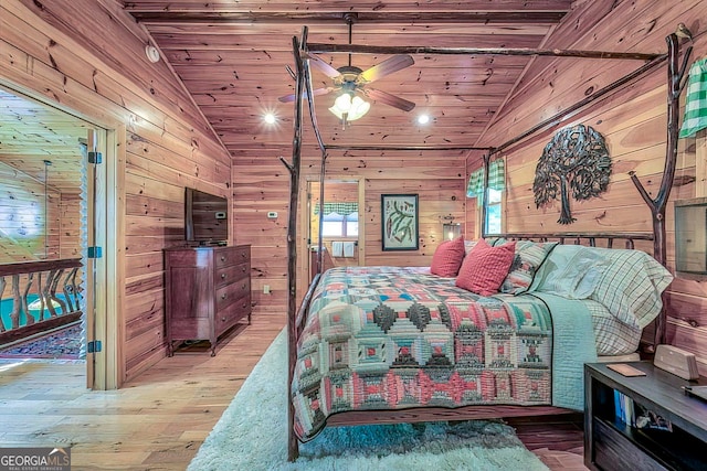 bedroom featuring hardwood / wood-style flooring, wooden walls, wood ceiling, and vaulted ceiling