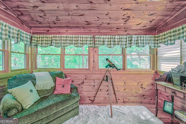 sunroom with wooden ceiling, plenty of natural light, and lofted ceiling