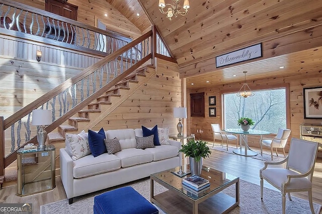 living area with stairway, wood ceiling, wooden walls, high vaulted ceiling, and light wood-type flooring