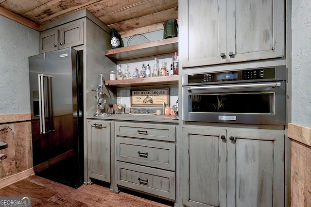 kitchen featuring gray cabinets, appliances with stainless steel finishes, and wooden ceiling