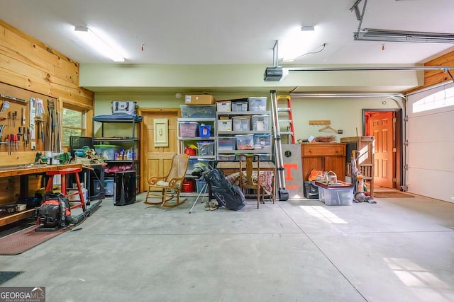 garage featuring a garage door opener and a workshop area