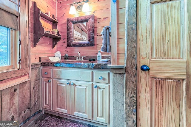 bathroom featuring wood walls and vanity