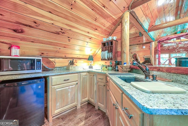 kitchen with light hardwood / wood-style floors, vaulted ceiling, dishwasher, wooden walls, and wooden ceiling