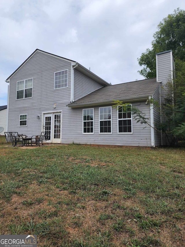 rear view of house featuring a patio, french doors, and a yard