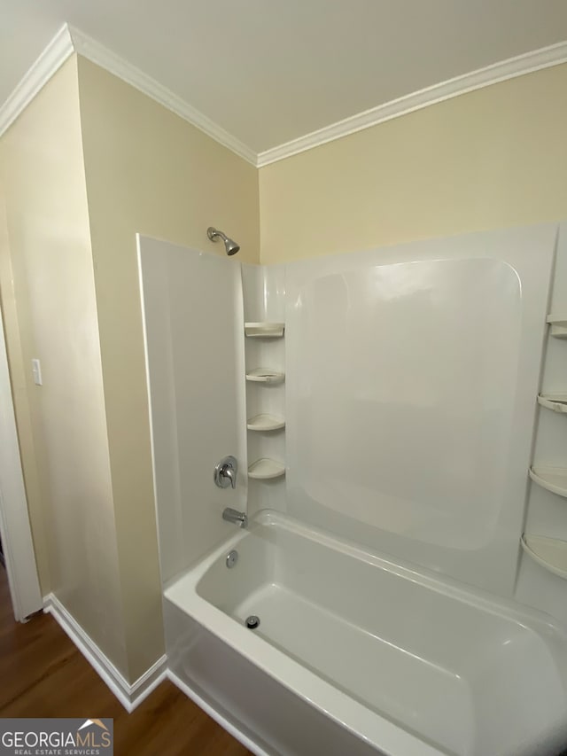 bathroom featuring shower / bath combination, hardwood / wood-style floors, and crown molding