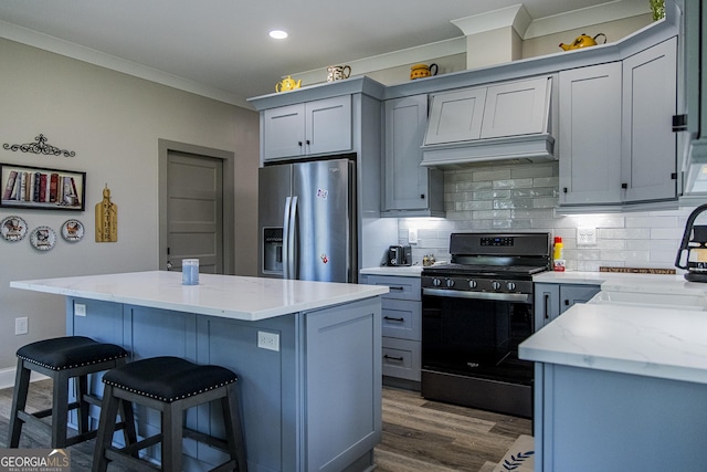 kitchen with light stone countertops, stainless steel fridge with ice dispenser, a center island, and black range with electric stovetop