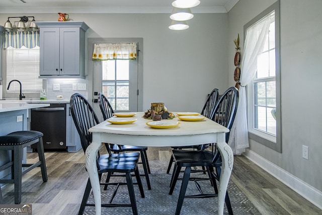 dining room with plenty of natural light, dark hardwood / wood-style flooring, and crown molding