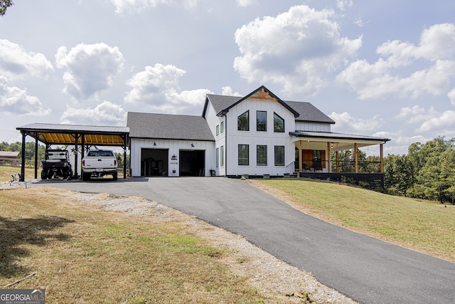 view of front facade with a carport, a porch, a garage, and a front yard