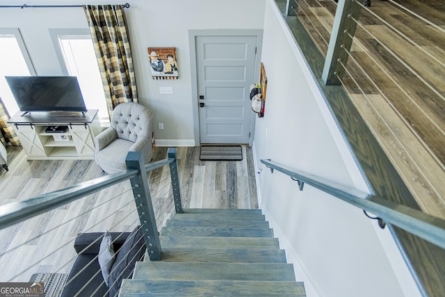 stairs with hardwood / wood-style flooring