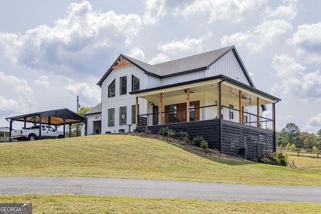 view of front facade featuring a front yard, a porch, and a carport