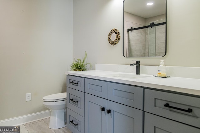 bathroom with tile patterned flooring, vanity, toilet, and an enclosed shower