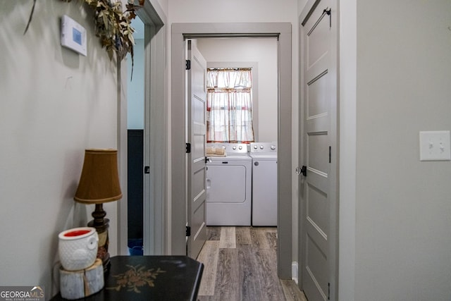 laundry area with light hardwood / wood-style floors and independent washer and dryer