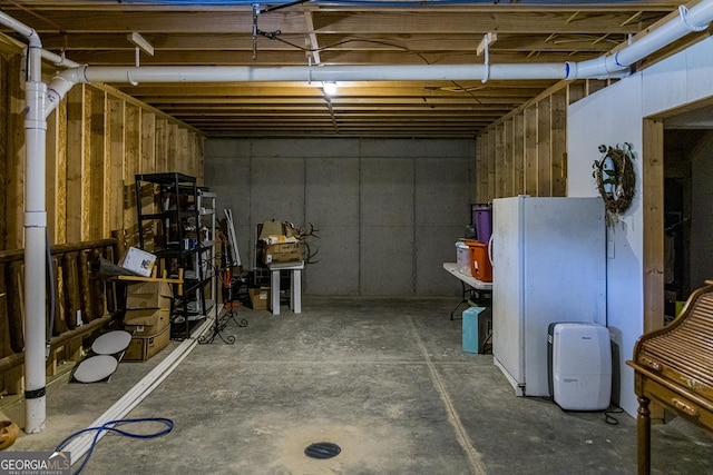 basement with white fridge