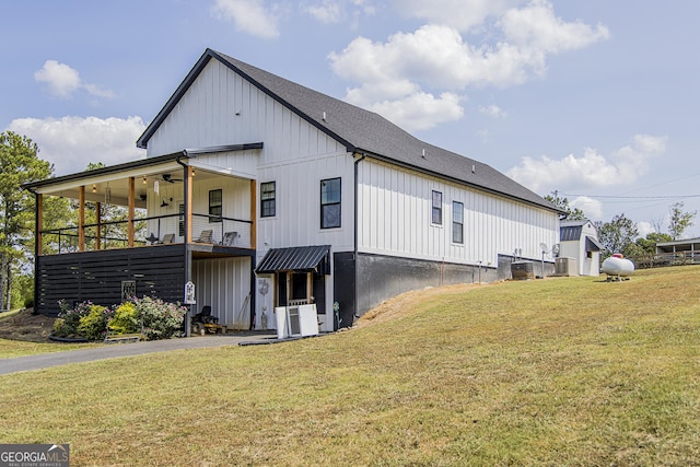 view of property exterior featuring a yard, ceiling fan, and central air condition unit