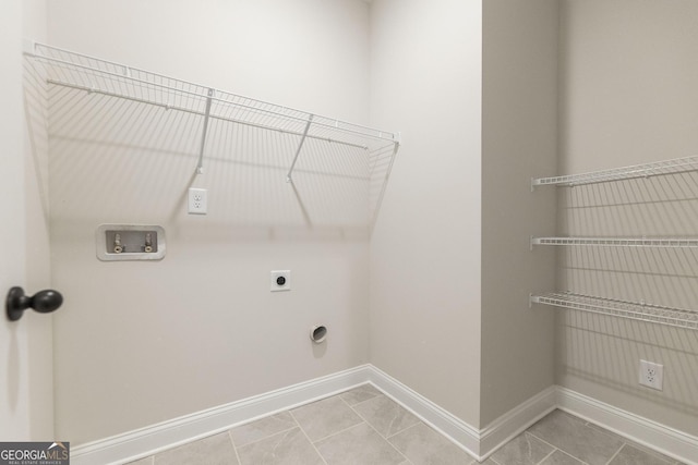 clothes washing area with hookup for a washing machine, laundry area, hookup for an electric dryer, and baseboards