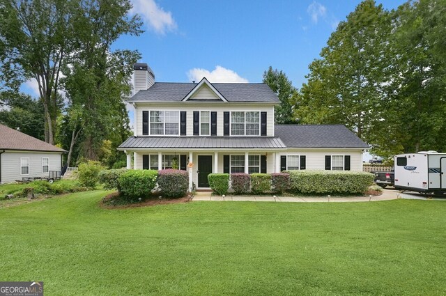 view of front of home with a porch and a front lawn