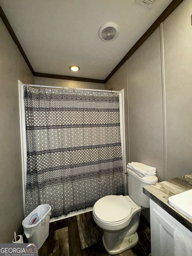 bathroom with a shower with curtain, vanity, hardwood / wood-style floors, and toilet