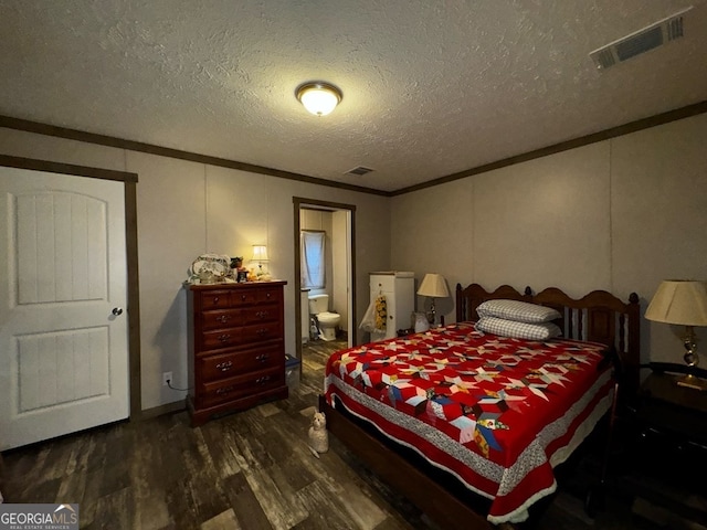 bedroom featuring ornamental molding, a textured ceiling, and dark wood-type flooring