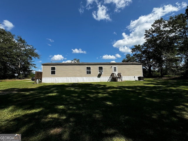 rear view of property with a lawn