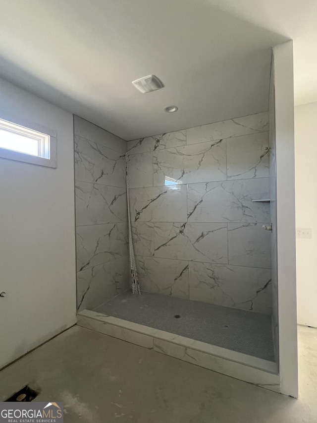 bathroom with a tile shower