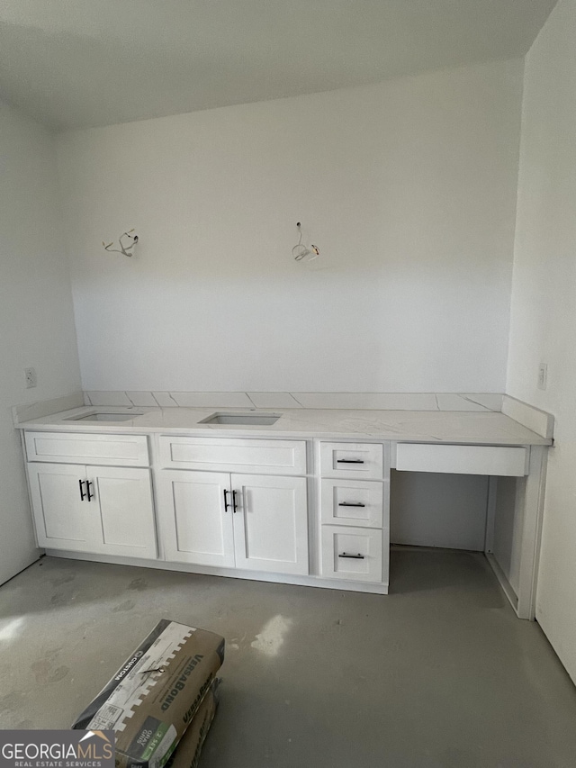 interior space with sink and concrete floors