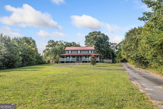 view of front of home featuring covered porch and a front yard