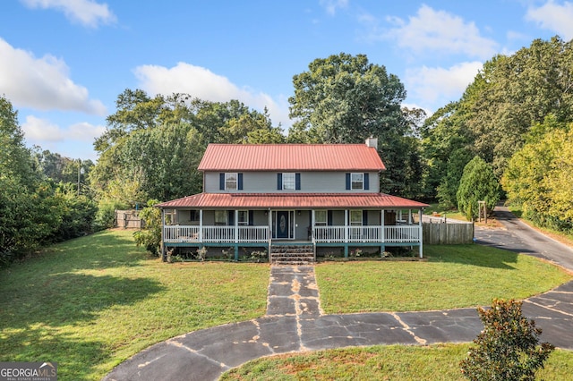 farmhouse inspired home featuring a front lawn and covered porch