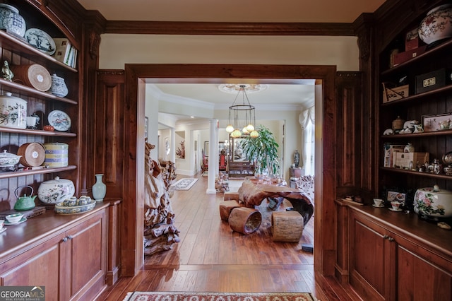 dining area featuring an inviting chandelier, crown molding, and light hardwood / wood-style floors