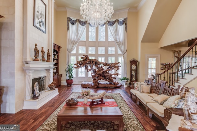 living room with ornamental molding, a towering ceiling, and dark hardwood / wood-style flooring