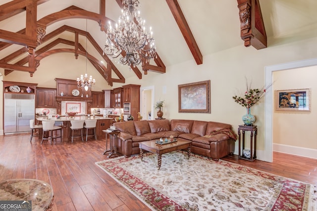 living room with beam ceiling, dark wood-type flooring, high vaulted ceiling, and a notable chandelier