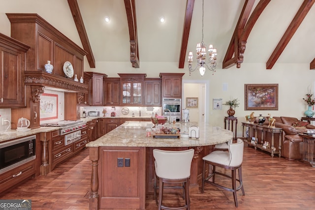 kitchen featuring a large island, stainless steel appliances, dark hardwood / wood-style floors, and beam ceiling