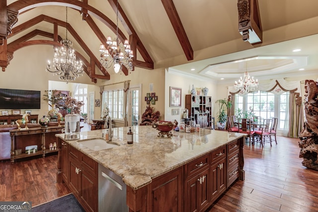 kitchen with an inviting chandelier, a large island, hanging light fixtures, and high vaulted ceiling