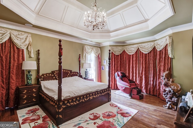 bedroom with an inviting chandelier, hardwood / wood-style floors, and crown molding