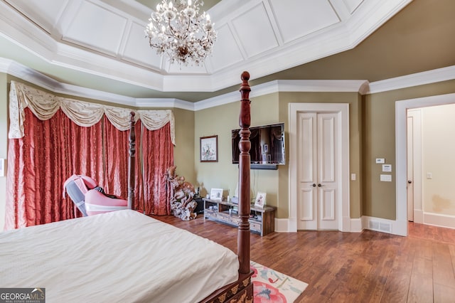 bedroom featuring ornamental molding, a chandelier, and hardwood / wood-style flooring