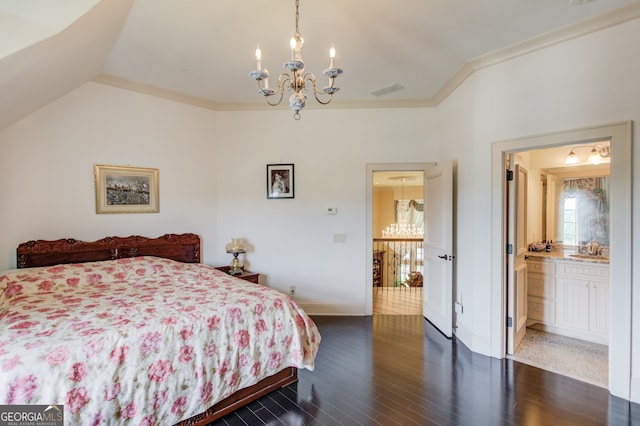 bedroom with dark wood-type flooring, lofted ceiling, an inviting chandelier, ensuite bath, and crown molding