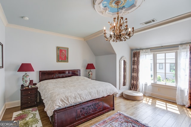 bedroom with crown molding, wood-type flooring, vaulted ceiling, and a notable chandelier