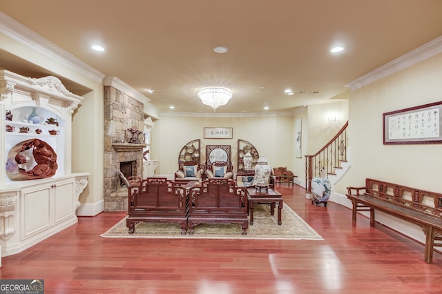 interior space with ornamental molding, hardwood / wood-style floors, and a fireplace