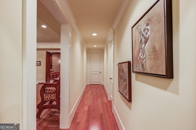 hall featuring ornamental molding and hardwood / wood-style floors