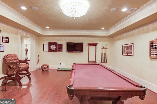 rec room with pool table, ornamental molding, hardwood / wood-style floors, and a notable chandelier