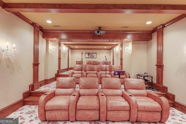 cinema room featuring wood-type flooring and beamed ceiling