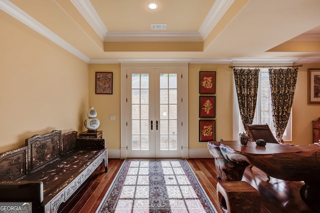 interior space with french doors, ornamental molding, hardwood / wood-style floors, and a wealth of natural light